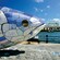 A ceramic mosaic sculpture of a big fish situated next to a waterfront